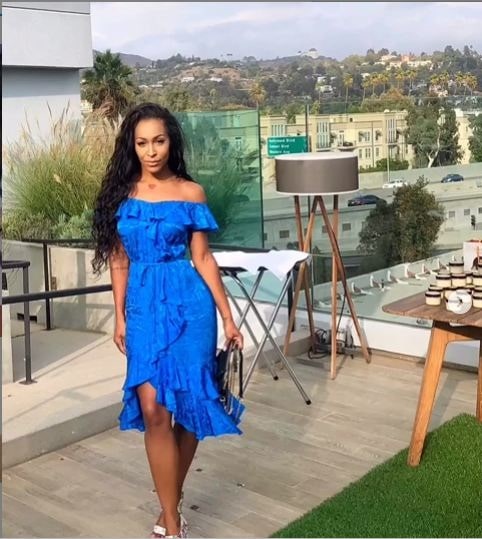 A picture of Amina Buddafly in a beautiful blue dress.